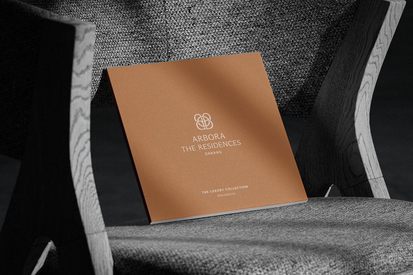 The Arbora brochure on a textured fabric chair