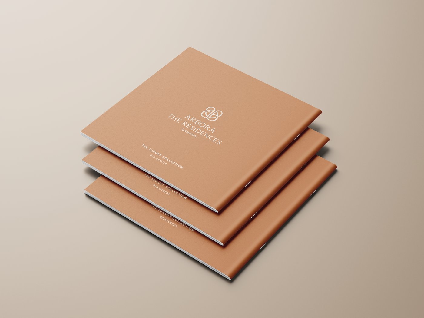 The brochure open to a spread — watercolour masterplan against typeset numbers