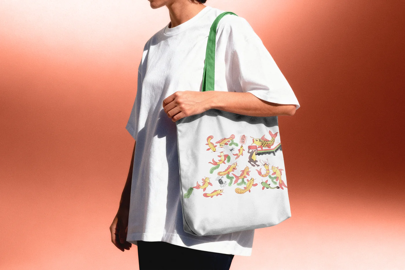Heavyweight canvas tote bag with emerald green handles featuring Hoc Le fish woodcut