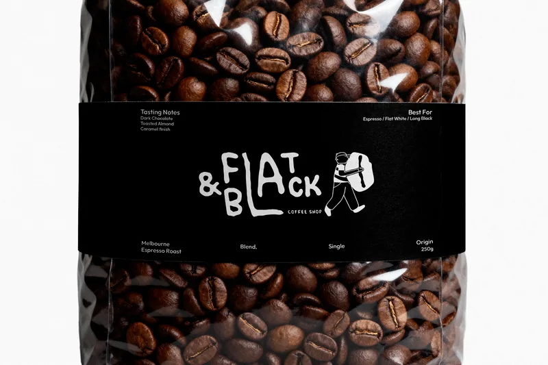 A clear bag of roasted beans with a black band label: tasting notes of dark chocolate, toasted almond and a caramel finish; best for espresso, flat white and long black; the carrier walking across the wordmark.