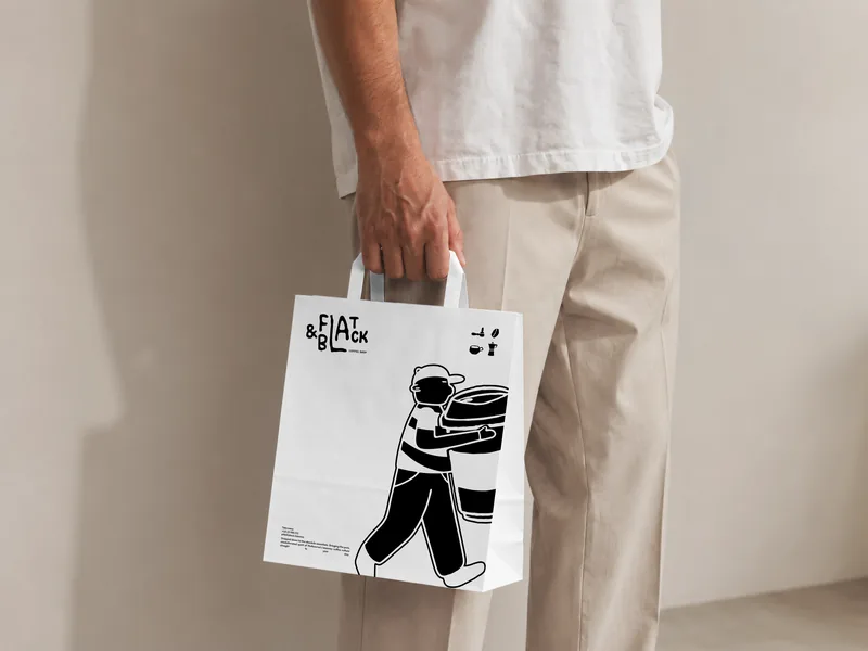 A white tote bag carried at the hip, printed with the carrier walking and the wordmark above him.