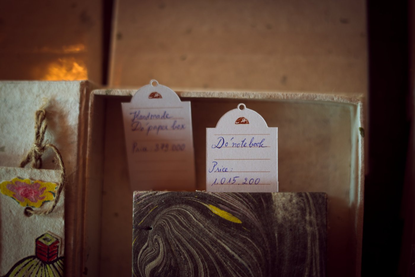 Handwritten price cards on the shelf