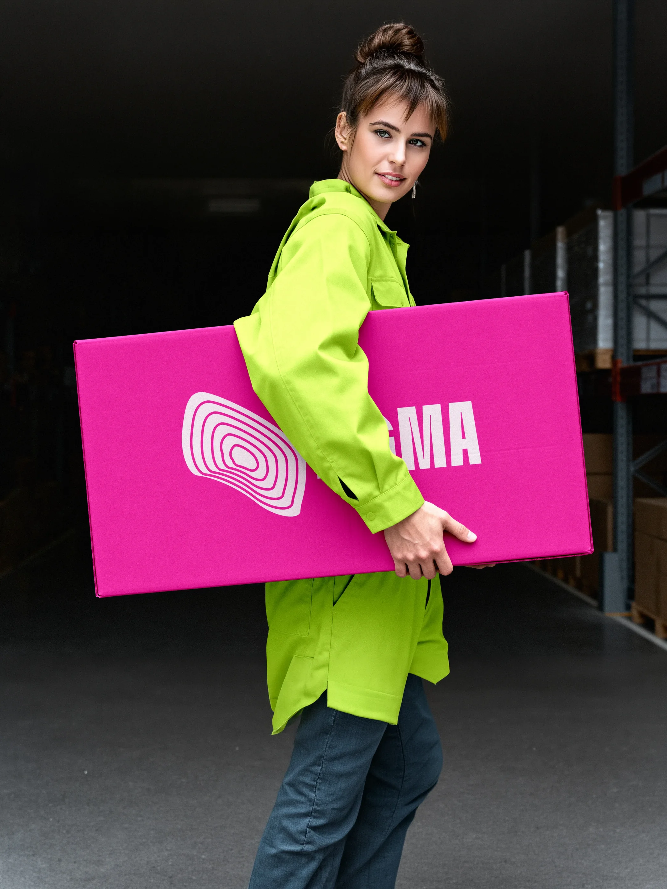 A model in a citric coat carries a fuchsia IGMA board.