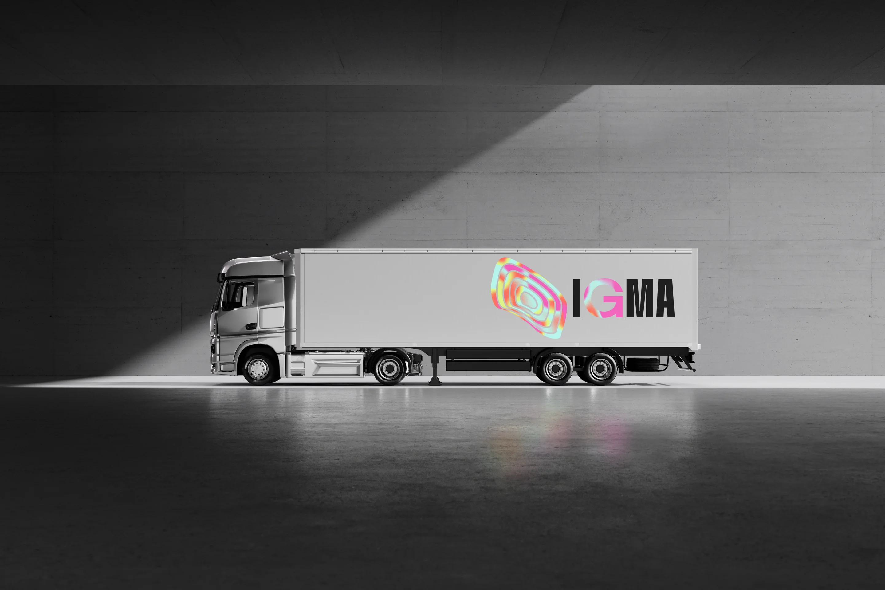 A white field truck carrying the IGMA mark in a dark hangar.