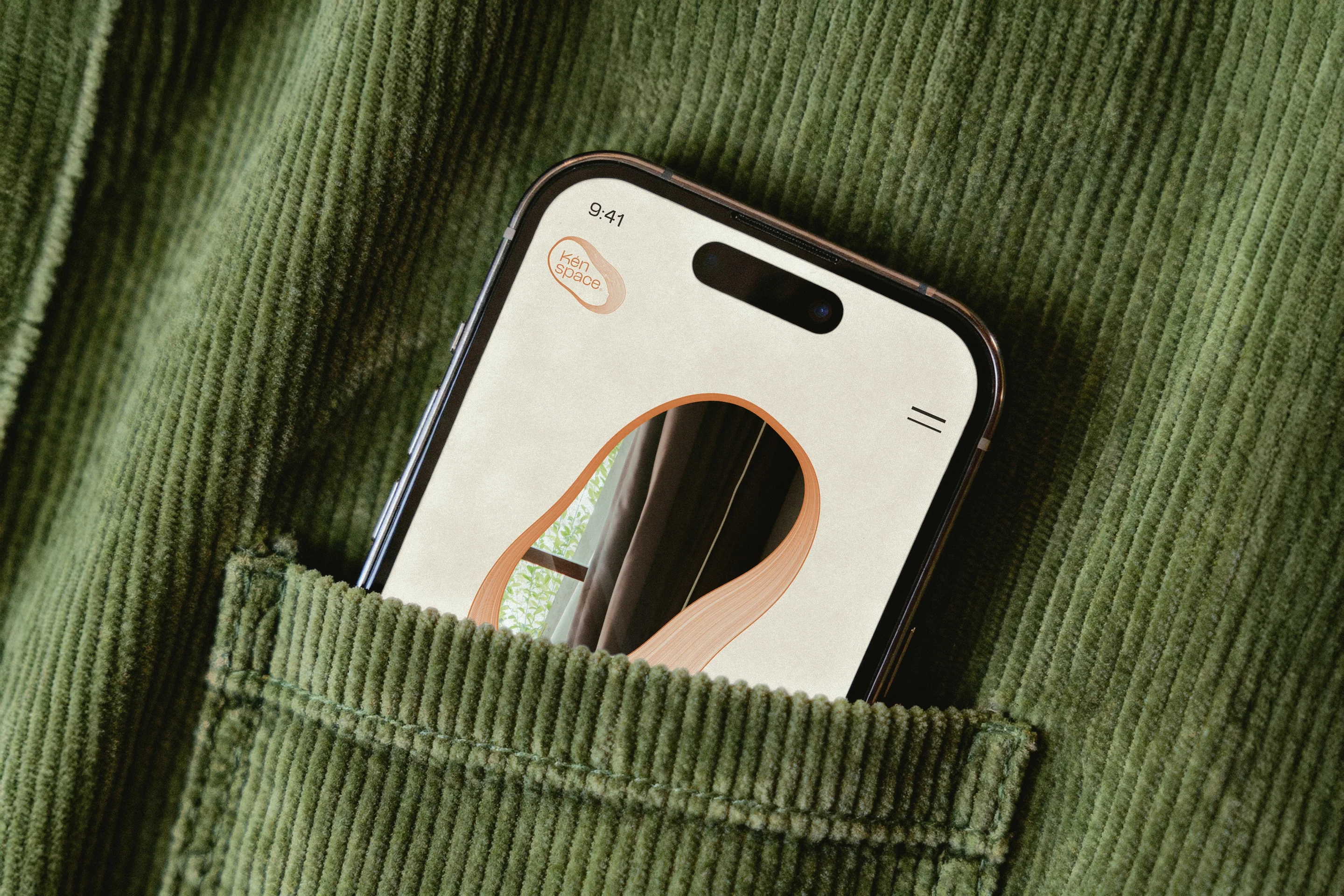 The resident app on a phone in a sage corduroy pocket.