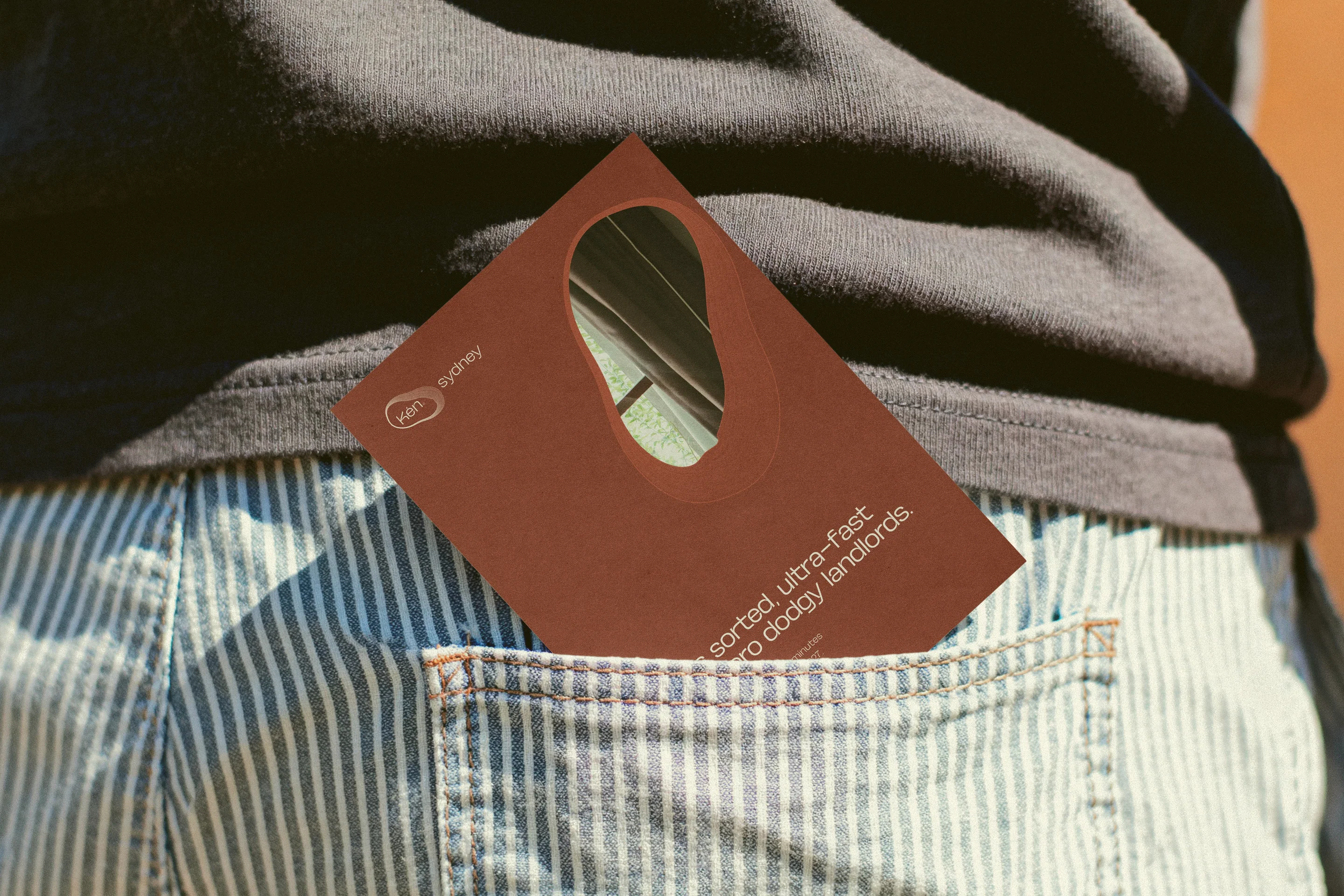 A copper RFID room keycard tucked into a back pocket.