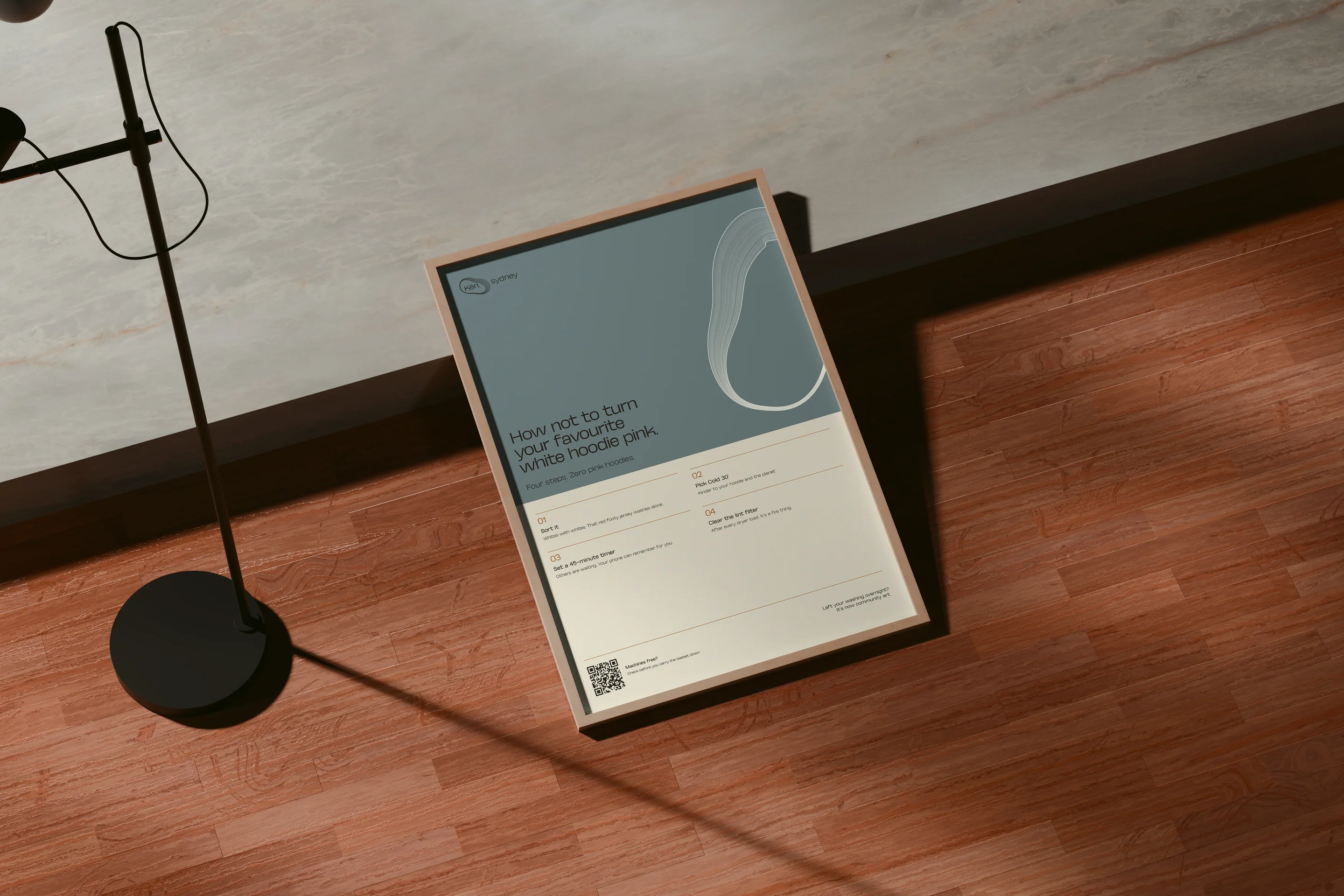 A framed kitchen poster leaning on the floor beside a lamp.