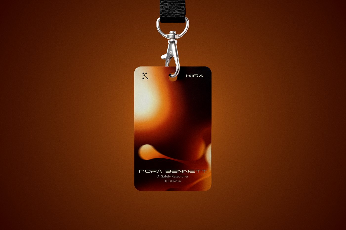Kira staff ID card on a lanyard — Nora Bennett, AI Safety Researcher