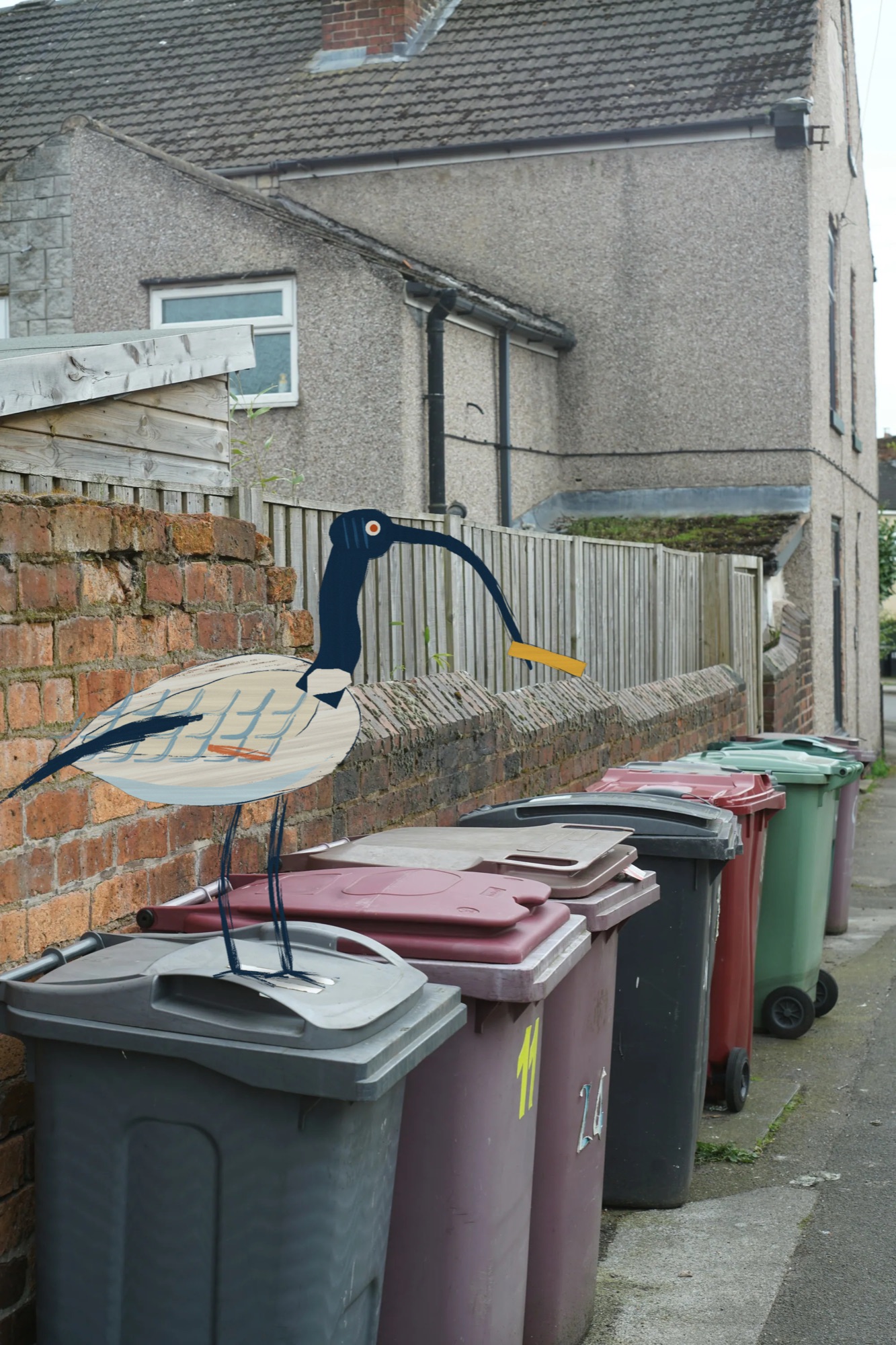 Painted bin chicken standing on a row of kerbside wheelie bins
