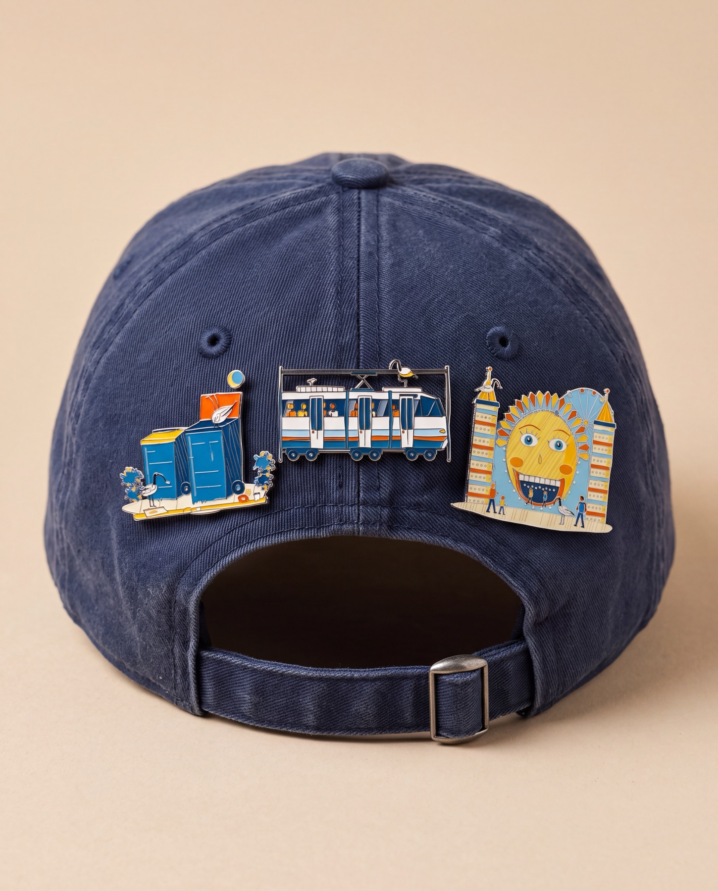 Navy cap with enamel pins of Sydney scenes along the back strap