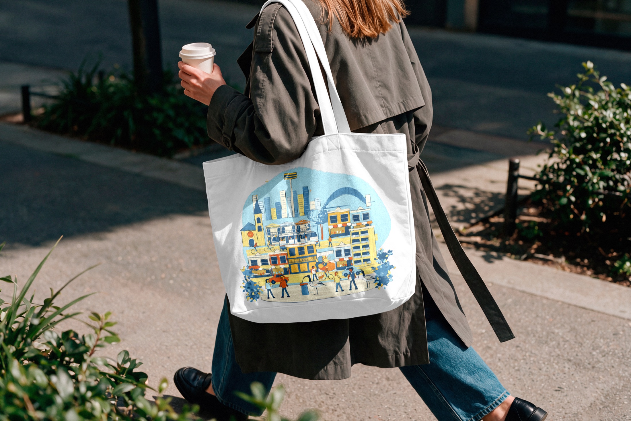 Person walking with a canvas tote printed with Sydney scenes