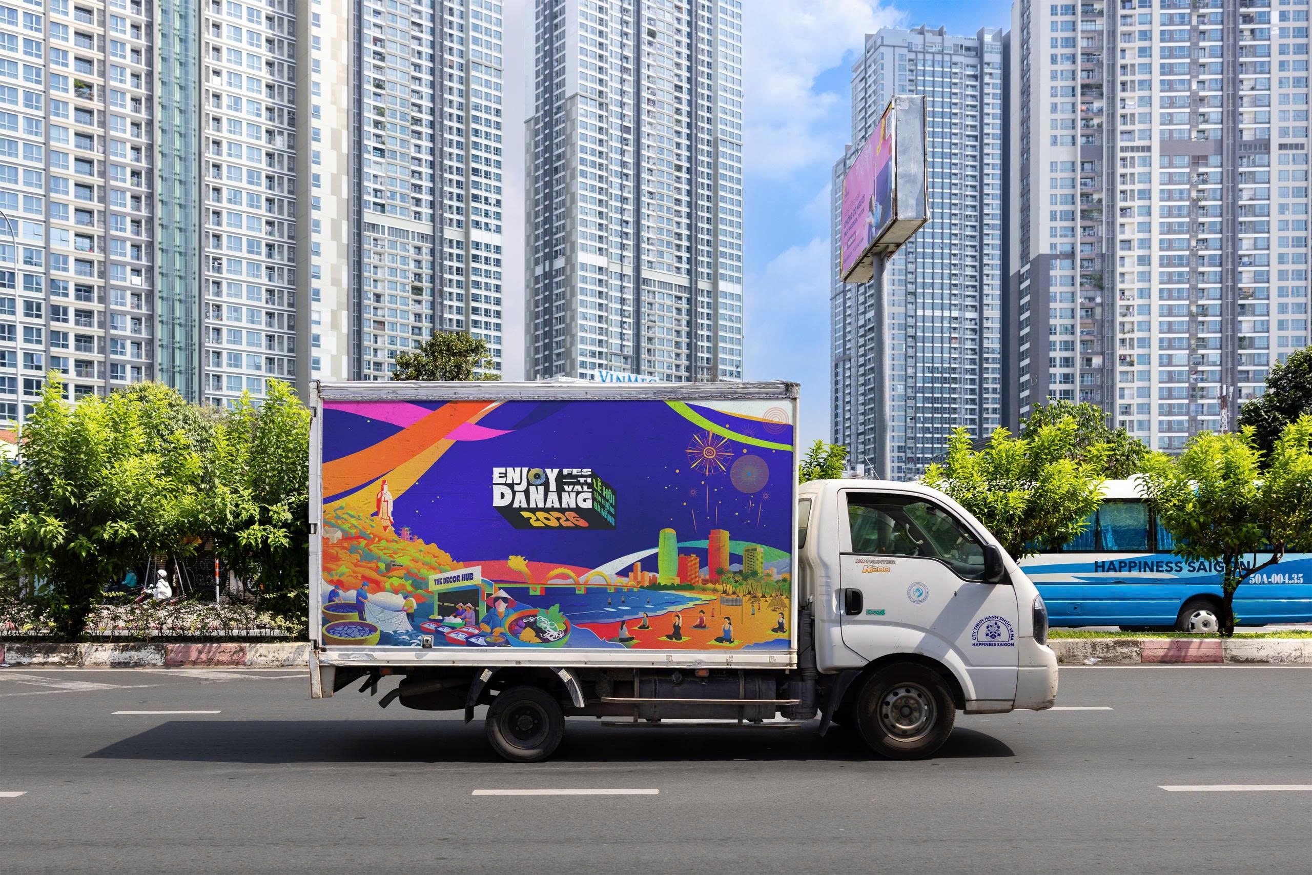Enjoy Danang identity wrapping a delivery truck in traffic.