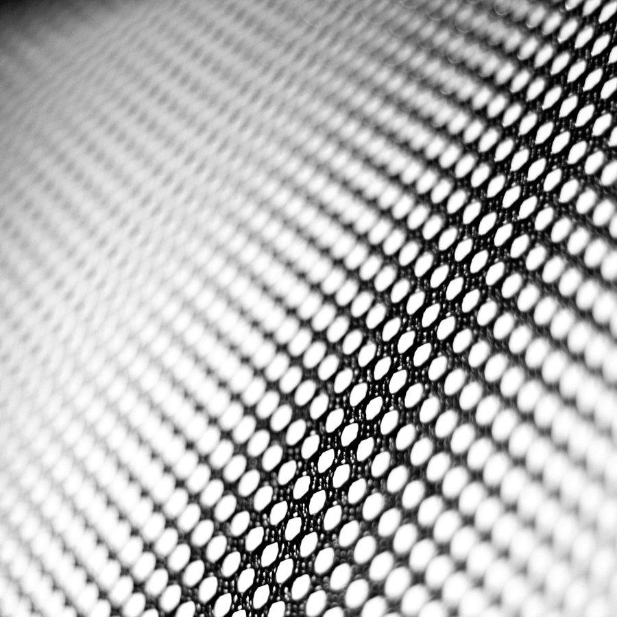 A precise halftone grid seen on the turn — the system, set.